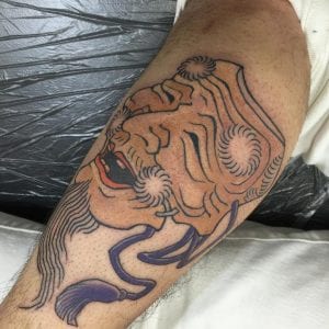Okina mask tattoo