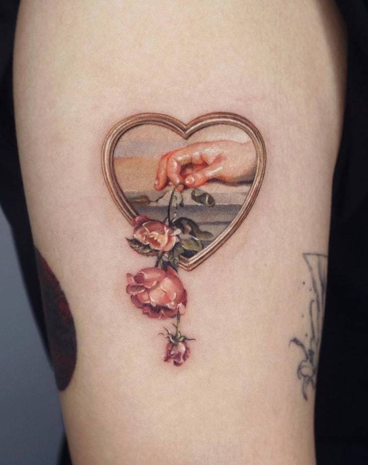 Hand Holding Flower Tattoo