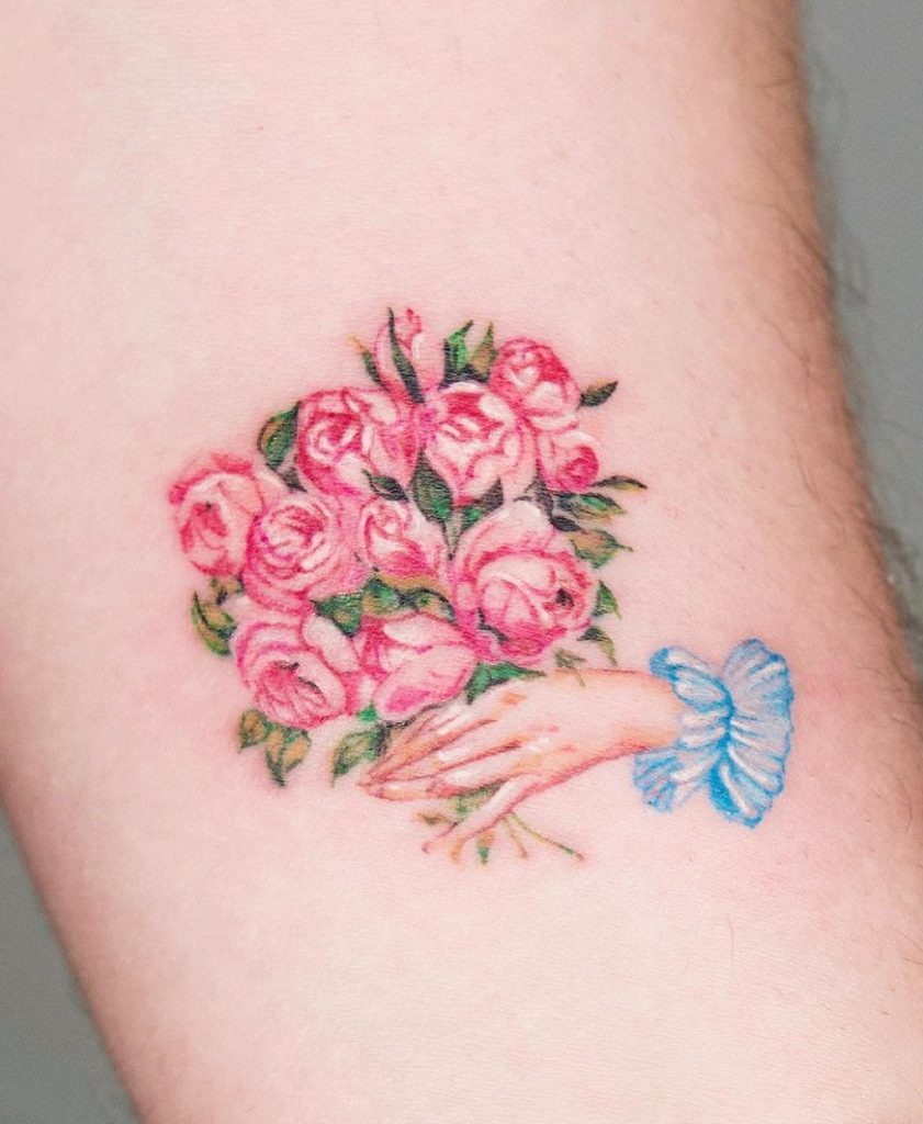 Hand Holding Flower Tattoo