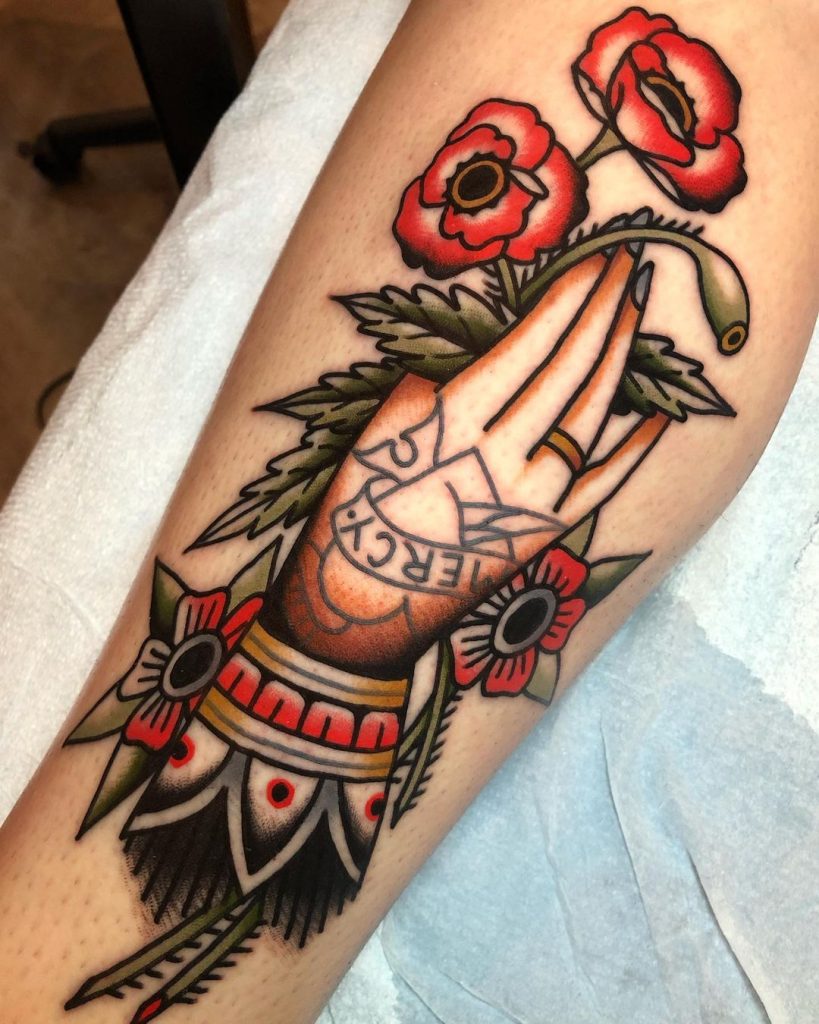 Hand Holding a Poppy Tattoo 