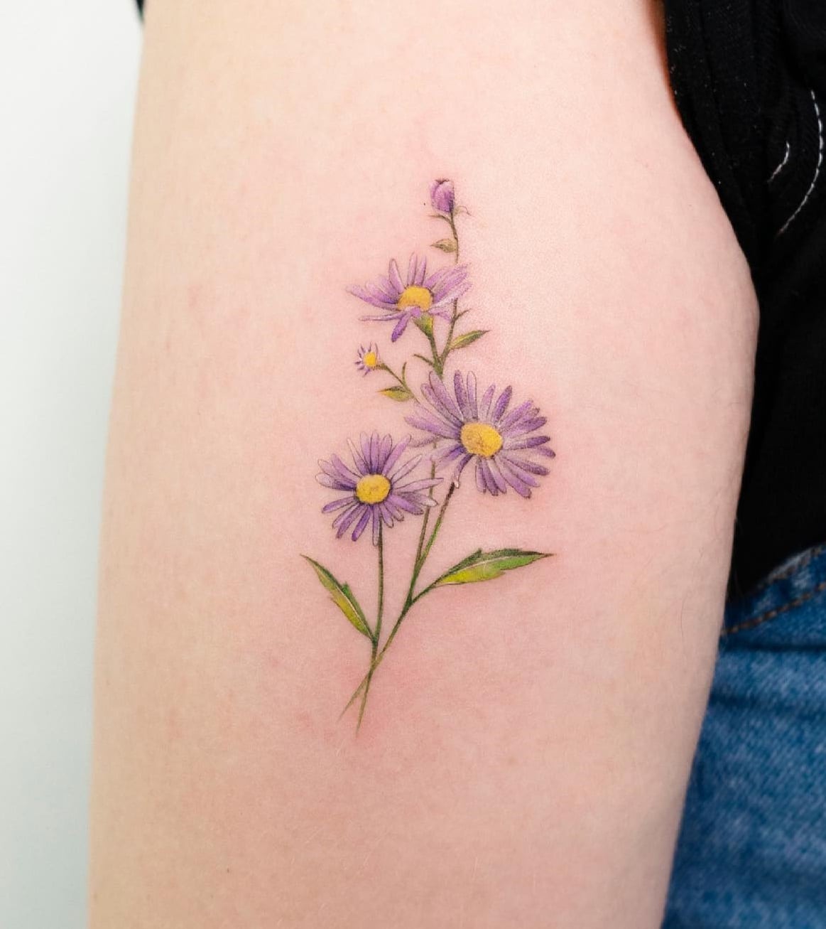 Fine line flower bouquet tattoo located on the inner