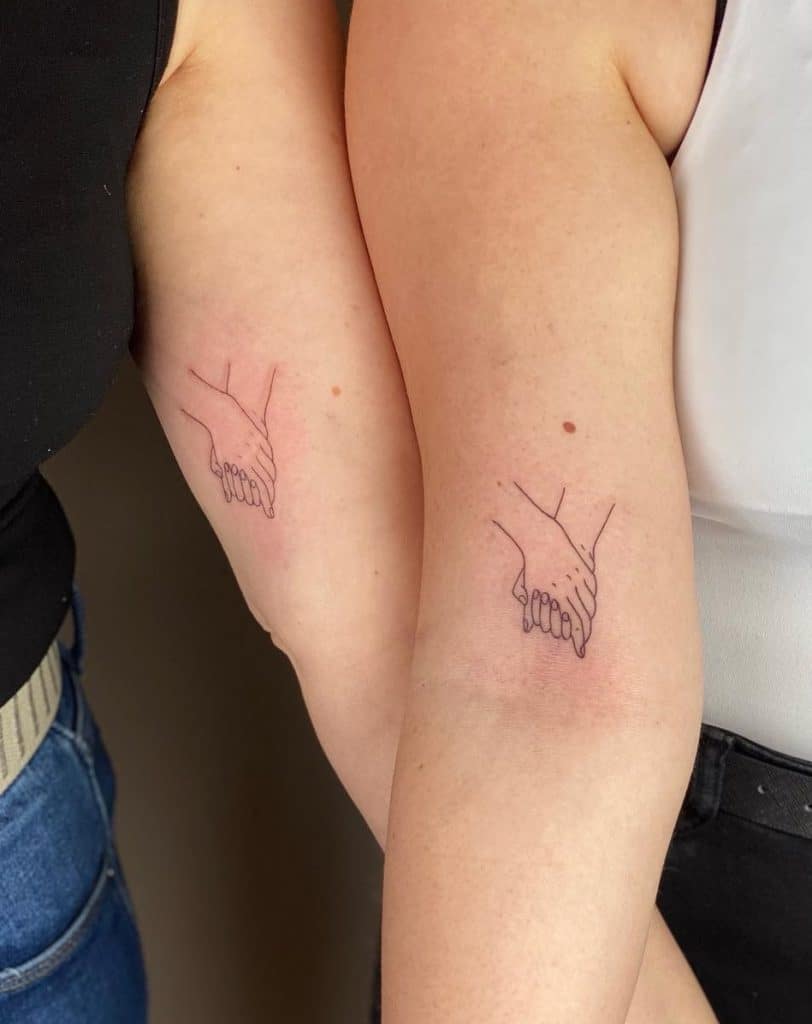 Hand Holding Matching Tattoos